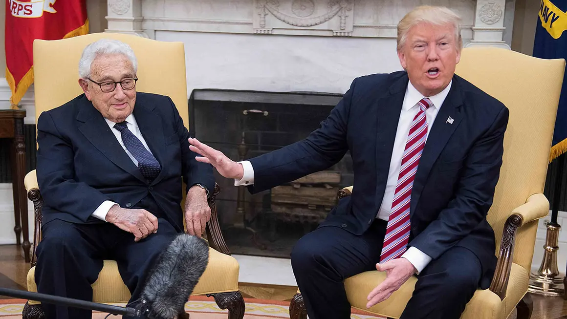 (FILES) US President Donald Trump (R) speaks with former US Secretary of State Henry Kissinger during a meeting in the Oval Office of the White House in Washington, DC, May 10, 2017. Former US secretary of state Henry Kissinger, a key figure of American diplomacy in the post-World War II era, died November 29, 2023 at the age of 100, his association said. (Photo by JIM WATSON / AFP)