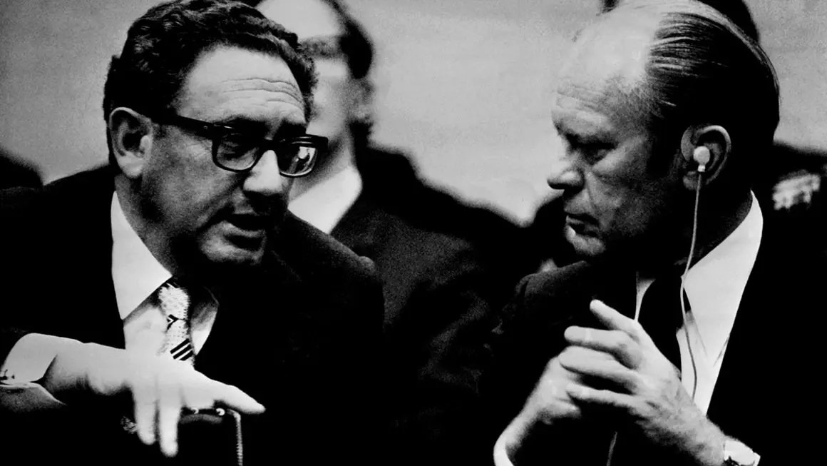 (FILES) US Secretary of State Henry Kissinger (L) speaks with US President Gerald Ford during the NATO 1975 summit on May 29, 1975 in Brussels. Former US secretary of state Henry Kissinger, a key figure of American diplomacy in the post-World War II era, died November 29, 2023 at the age of 100, his association said. (Photo by AFP)
