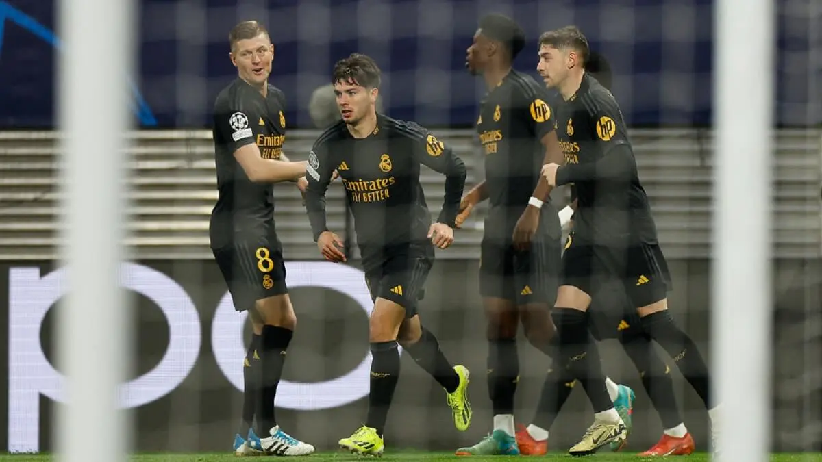 El delantero español del Real Madrid Brahim Díaz celebra el gol inicial con sus compañeros durante el partido de fútbol de ida de octavos de final de la UEFA Champions League entre el RB Leipzig y el Real Madrid CF en Leipzig, Alemania, el 13 de febrero de 2024 – PHOTO/Odd ANDERSEN/AFP