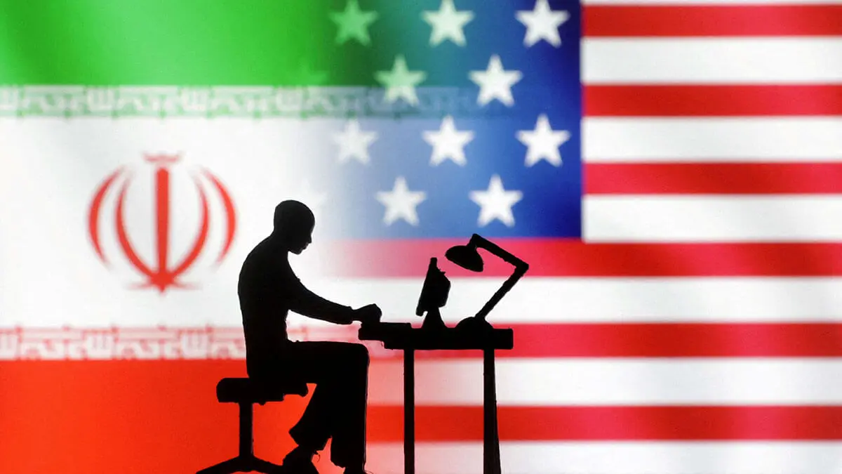 Ilustración de figuras con computadoras frente a las banderas de EE. UU. e Irán - REUTERS/ DADO RUVIC