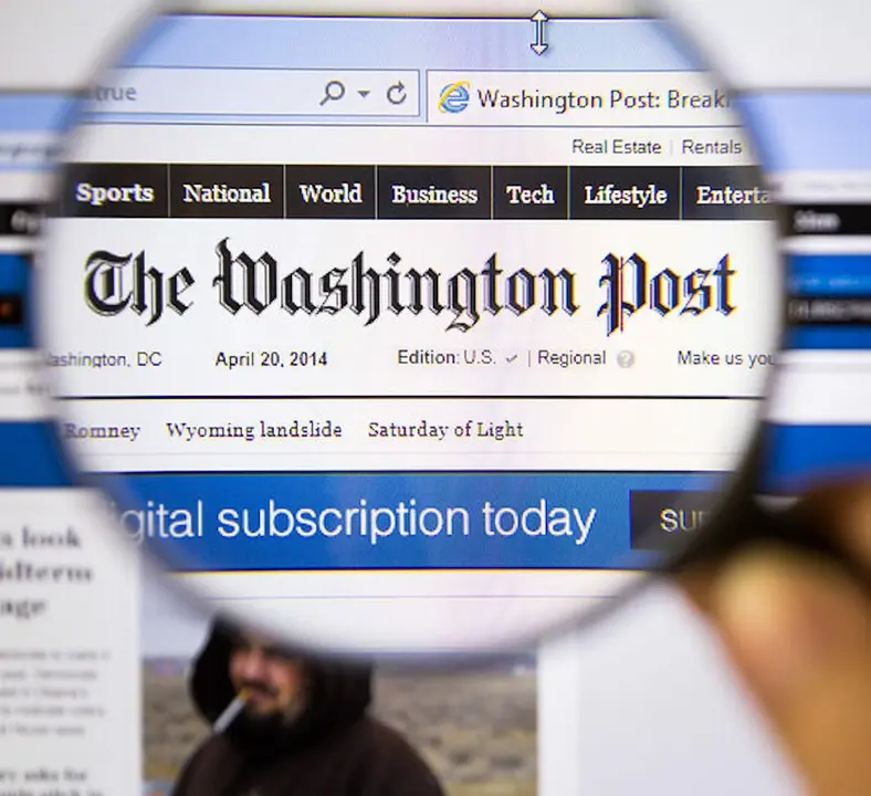 Bangkok Thailand  APRIL 20 2014: Photo of The Washington Post Monitor homepage on a monitor screen through a magnifying glass.