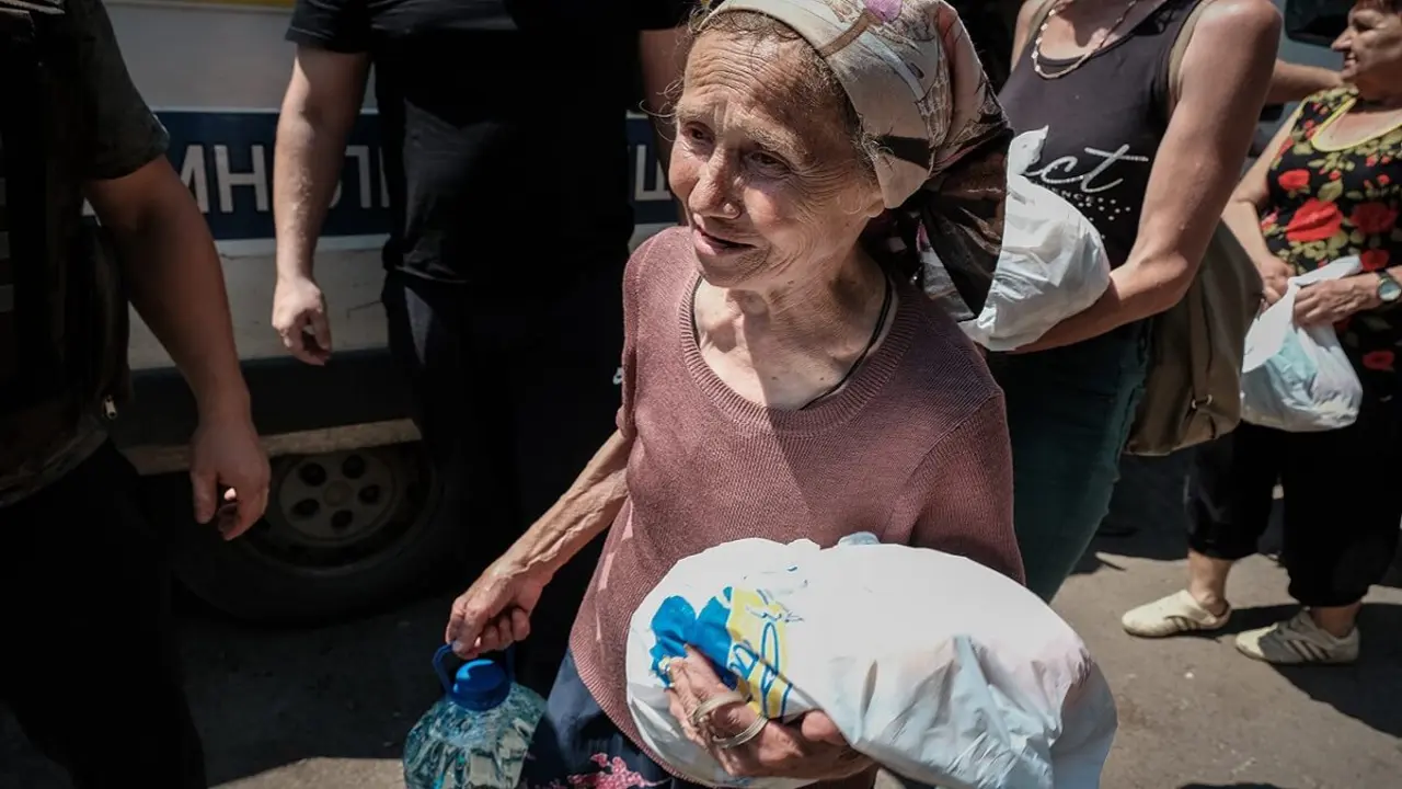 PHOTO/MARÍA SENOVILLA - Una vecina de Chasiv Yar, que no ha querido evacuar de esta devastada ciudad, recoge la ayuda humanitaria que los voluntarios llevan todas las semanas (1)