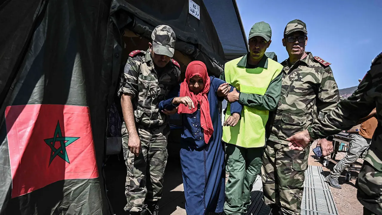 AFP/PHILIPPE LÓPEZ - Personal militar atiende a un sobreviviente del terremoto del 8 de septiembre en un hospital de campaña militar en la aldea de Asni, cerca de Moulay Brahim, en la provincia de al-Haouz, en las montañas del Alto Atlas en el centro de Marruecos, el 11 de septiembre de 2023