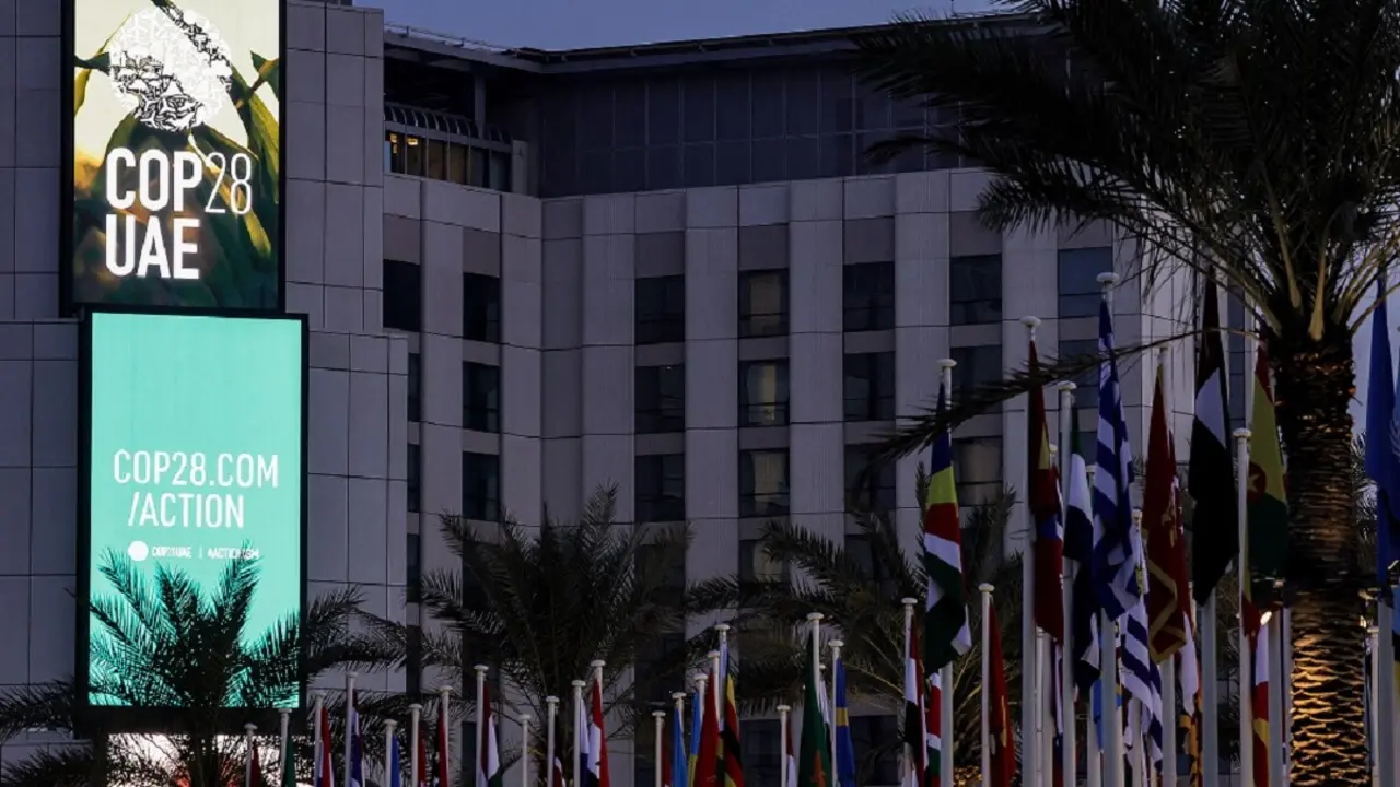 El logotipo de la Conferencia de las Naciones Unidas sobre el Cambio Climático COP28 aparece junto a las banderas de los países participantes en la Expo City de Dubái el 12 de diciembre de 2023 - PHOTO/AFP/GIUSEPPE CACACE