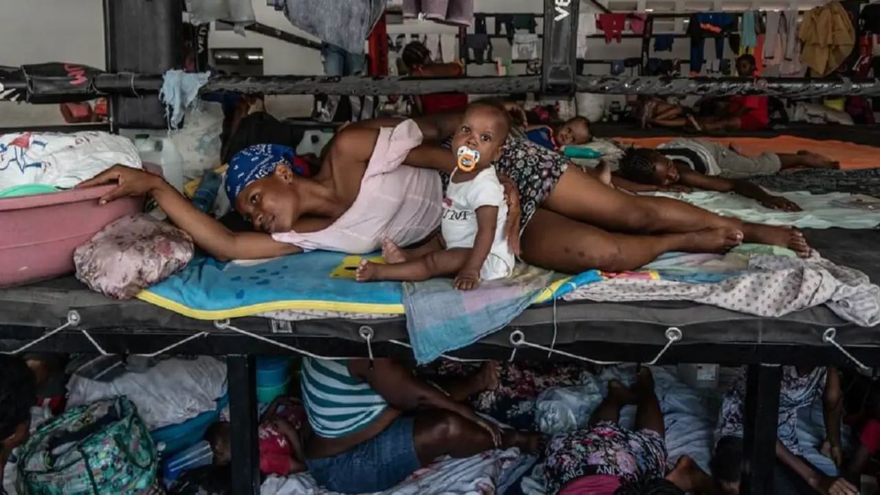 Hombres, mujeres y niños desplazados refugiados en un estadio de boxeo en el centro de Puerto Príncipe tras huir de sus hogares durante los ataques de bandas en agosto de 2023 -&nbsp;© OCHA/Giles Clarke
