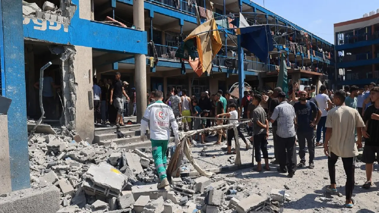 Palestinos examinan los daños tras el bombardeo militar israelí de la escuela Abu Oreiban, convertida en refugio, gestionada por el OOPS (Organismo de Obras Públicas y Socorro de las Naciones Unidas para los Refugiados de Palestina en el Cercano Oriente) – PHOTO/Eyad BABA/AFP