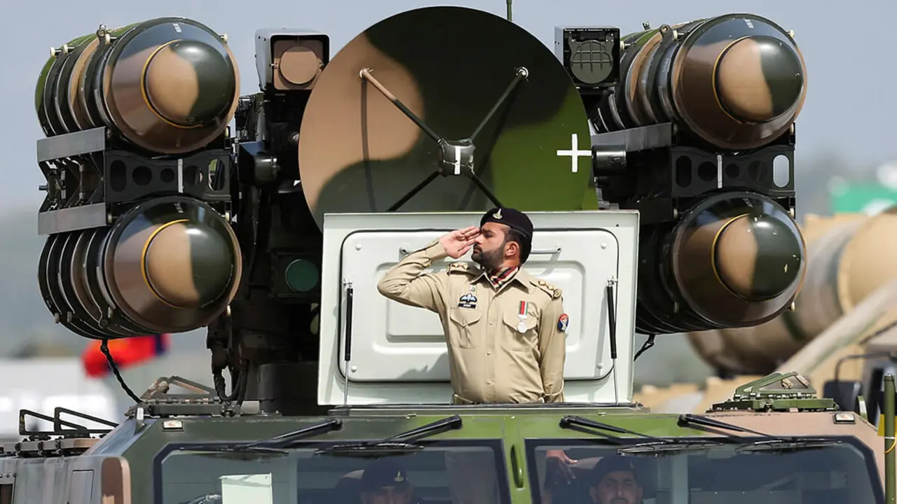 Un soldado del Ejército paquistaní saluda mientras está de pie sobre un sistema de misiles de defensa aérea durante el desfile militar del Día de Pakistán en Islamabad, Pakistán - REUTERS/SAIYNA BASHIR