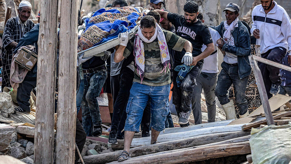 AFP/FADEL SENNA - La gente lleva los restos de una víctima del mortal terremoto de magnitud 6,8 del 8 de septiembre, en la aldea de Imi NTala, cerca de Amizmiz, en el centro de Marruecos, el 10 de septiembre de 2023