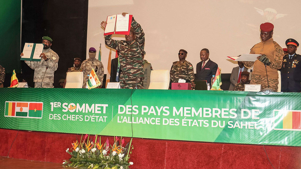 El jefe del Gobierno militar de Níger, el general Abdourahamane Tiani; el coronel maliense Assimi Goita; y el capitán burkinés Ibrahim Traore muestran los documentos de la Confederación de Estados del Sahel (AES) que firmaron durante su primera cumbre en Niamey el 6 de julio de 2024 - PHOTO/AFP