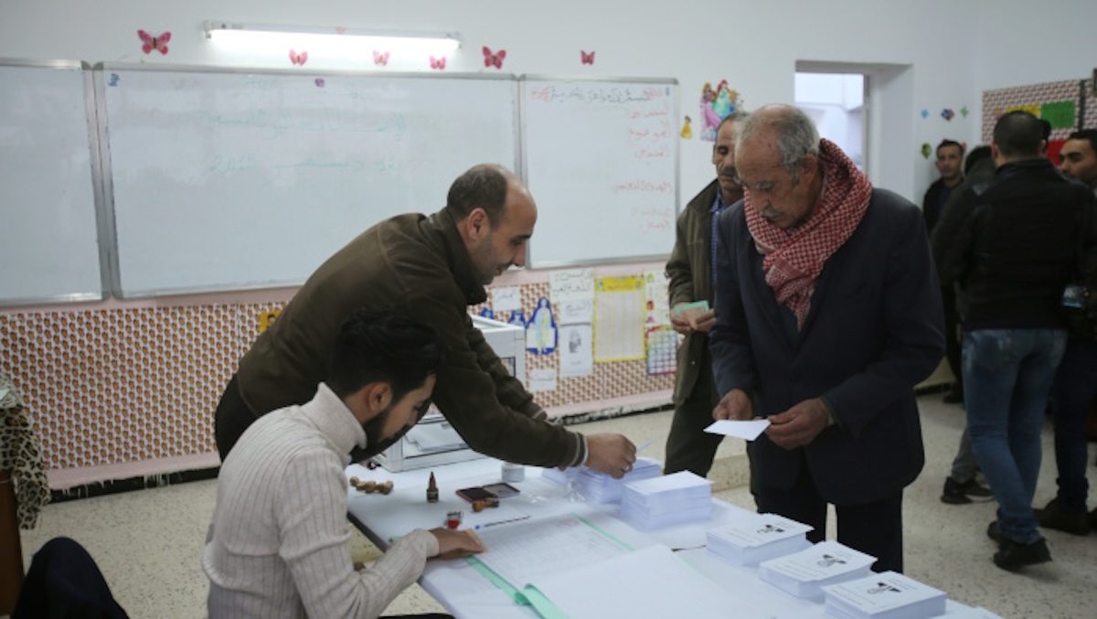 A voter receives ballots at a polling station during the presidential election in Algiers, Algeria December 12, 2019. REUTERS/Ramzi Boudina