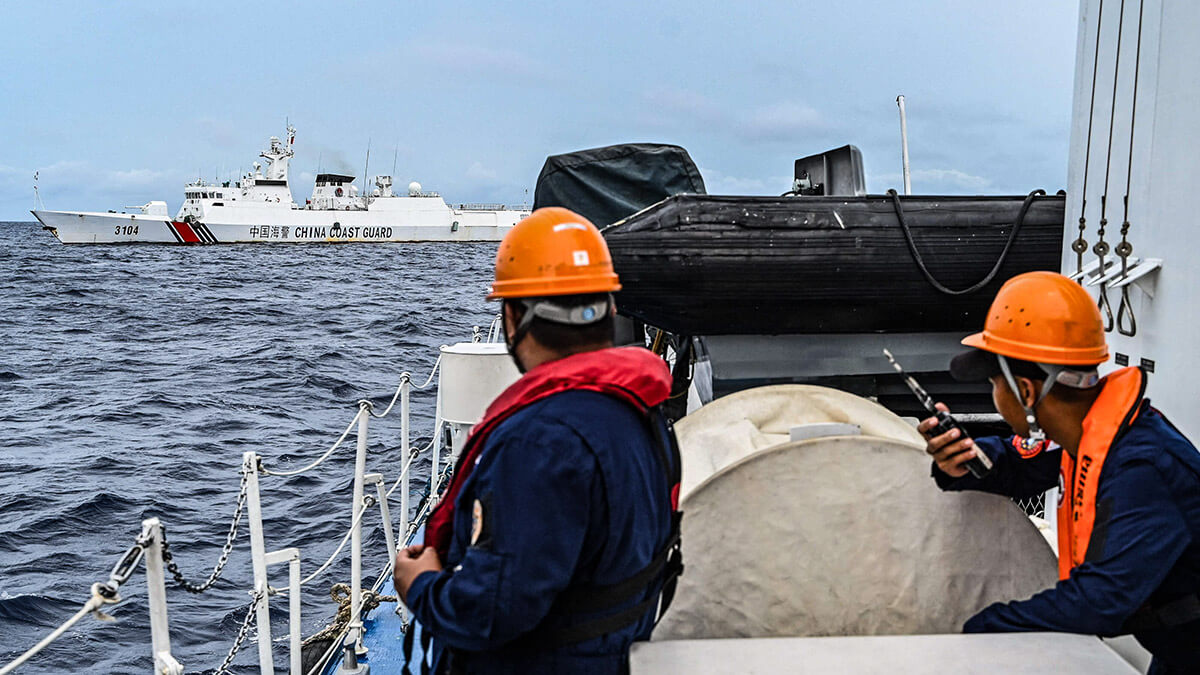 Un barco de la Guardia Costera de China es visto desde el buque de la Guardia Costera filipina BRP Cabra durante una misión de suministro a Sabina Shoal en aguas disputadas del Mar de China Meridional el 26 de agosto de 2024 - AFP/ JAM STA ROSA