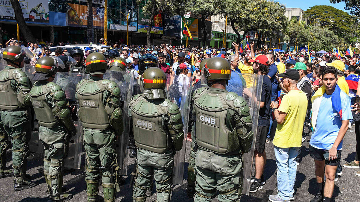 <p>Miembros de la Guardia Nacional Bolivariana venezolana se encuentran junto a manifestantes durante una protesta convocada por la oposición en vísperas de la investidura presidencial en Valencia, estado Carabobo, Venezuela, el 9 de enero de 2025 - PHOTO/ ARCHIVO<br />
</p>