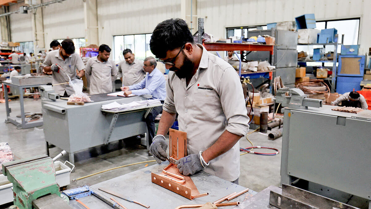 Empleados ensamblan un transformador eléctrico dentro de una unidad de fabricación de Inductotherm (India) Private Limited en Sanand GIDC (Gujarat Industrial Development Corporation), en las afueras de Ahmedabad, India - REUTERS/AMIT DAVE