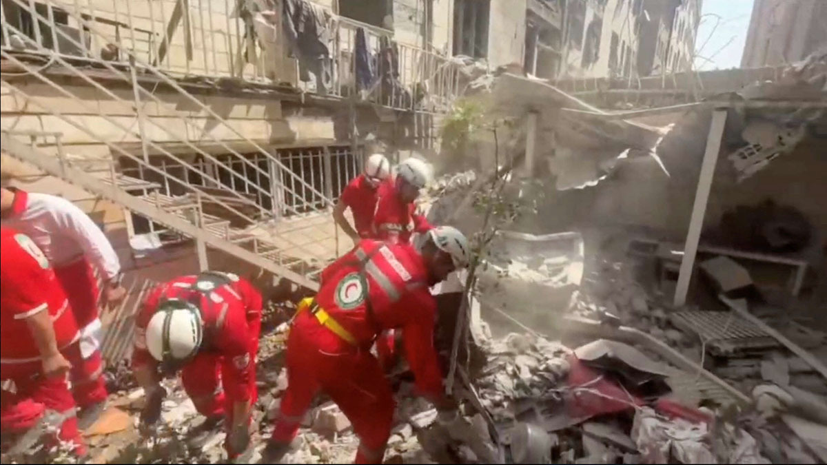 Rescuers work at the site of a damaged building, in the aftermath of Israeli strikes, in location given as Tehran, Iran, in this screen grab from a handout video released on June 14, 2025. Iranian Red Crescent Society/Handout via REUTERS ATTENTION EDITORS - THIS PICTURE WAS PROVIDED BY A THIRD PARTY. NO RESALES. NO ARCHIVES. MANDATORY CREDIT