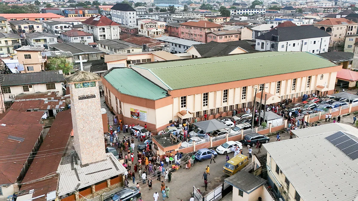 <p>Vista aérea con dron de cristianos saliendo de la iglesia católica de San Pedro y San Pablo tras la misa dominical en Palmgrove, Lagos, Nigeria, el 2 de noviembre de 2025 - REUTERS/ SODIQ ADELAKUN </p>
