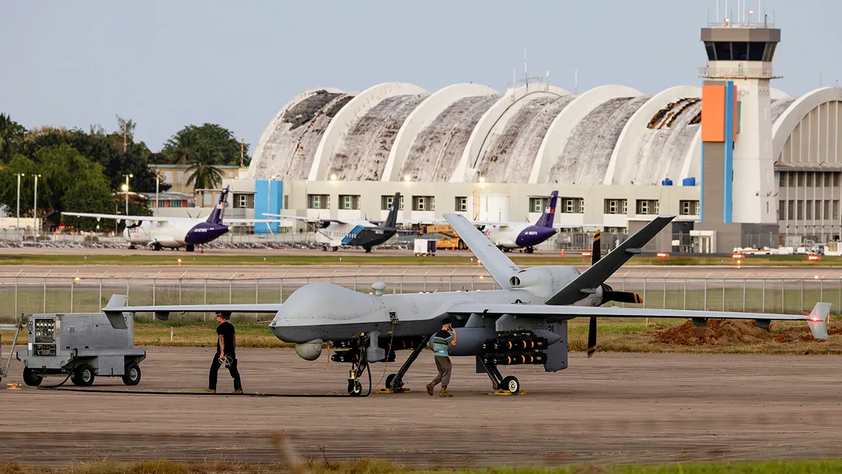 Personal trabajando en un avión MQ-9 Reaper de la Fuerza Aérea de los Estados Unidos estacionado en la pista del Aeropuerto Rafael Hernández, en medio de las tensiones entre la administración del presidente estadounidense Donald Trump y el gobierno del presidente venezolano Nicolás Maduro, en Aguadilla, Puerto Rico, el 26 de diciembre de 2025 - REUTERS/ EVA MARIE UZCATEGUI